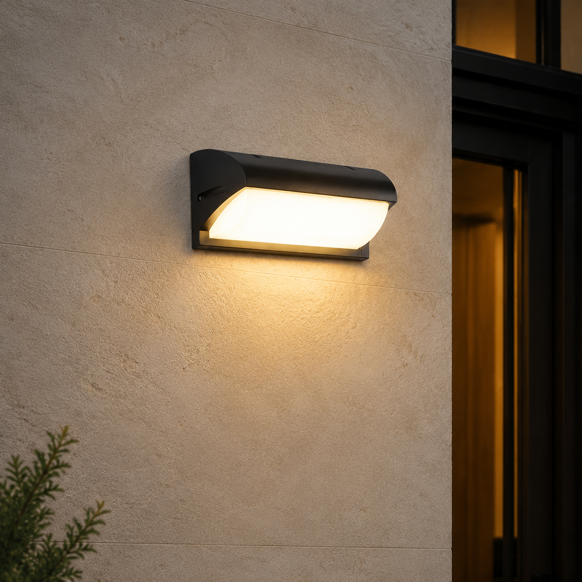 Black outdoor LED wall light glowing against a warm limestone exterior